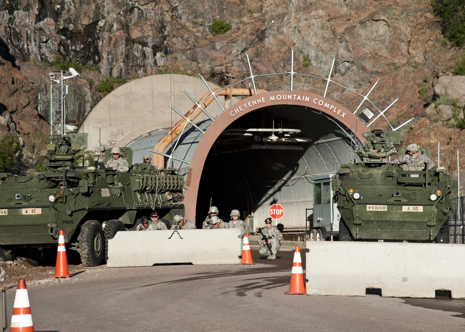 North Portal entrance arch of the Cheyenne Mountain Complex with soldiers and Stryker vehicles in front of it