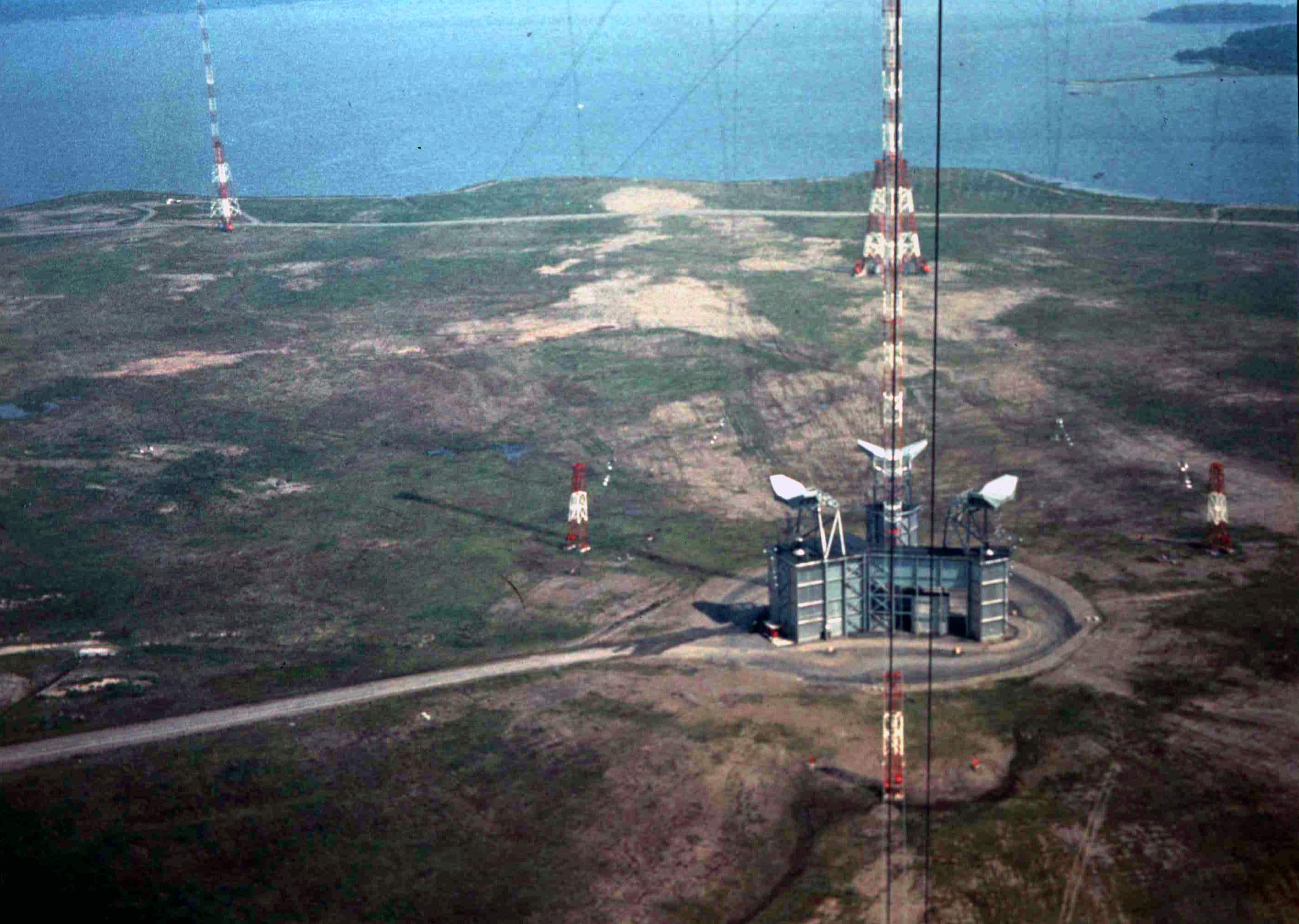 Aerial view of a building with a tall central mast