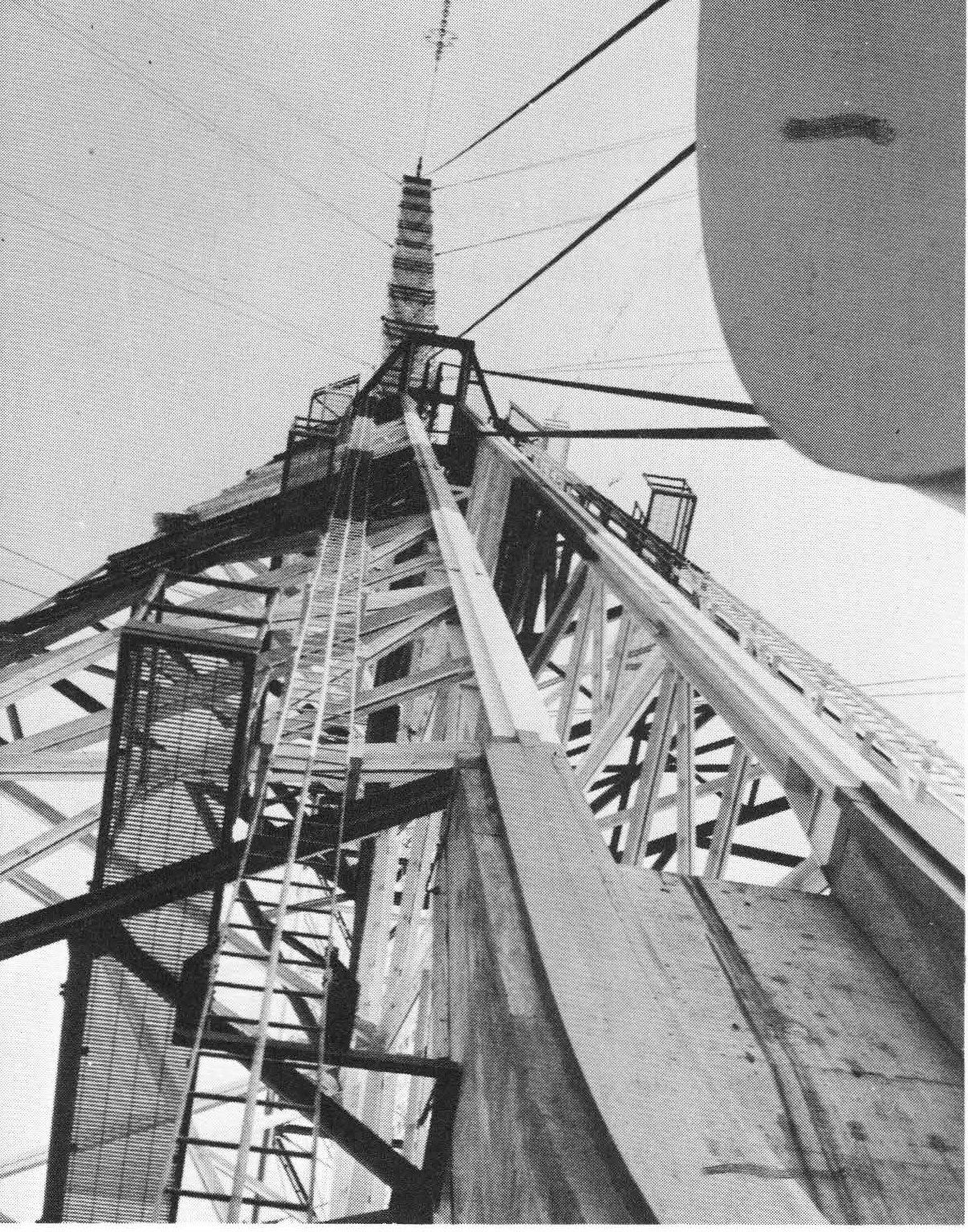 Black-and-white view up a lattice tower