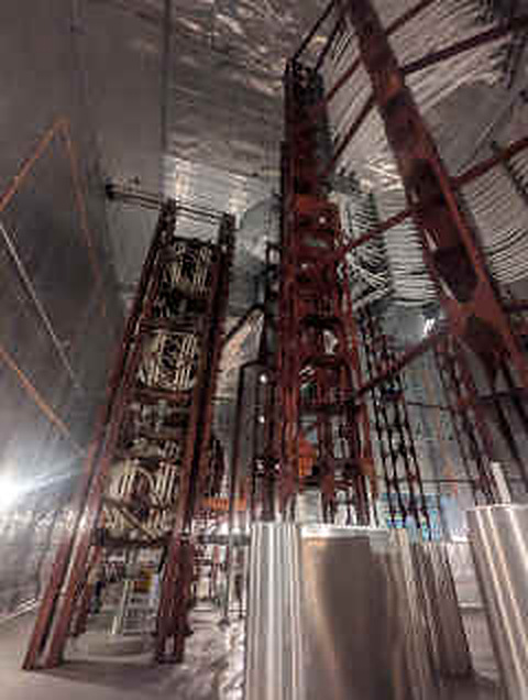 Tall frames of coils inside a large hall