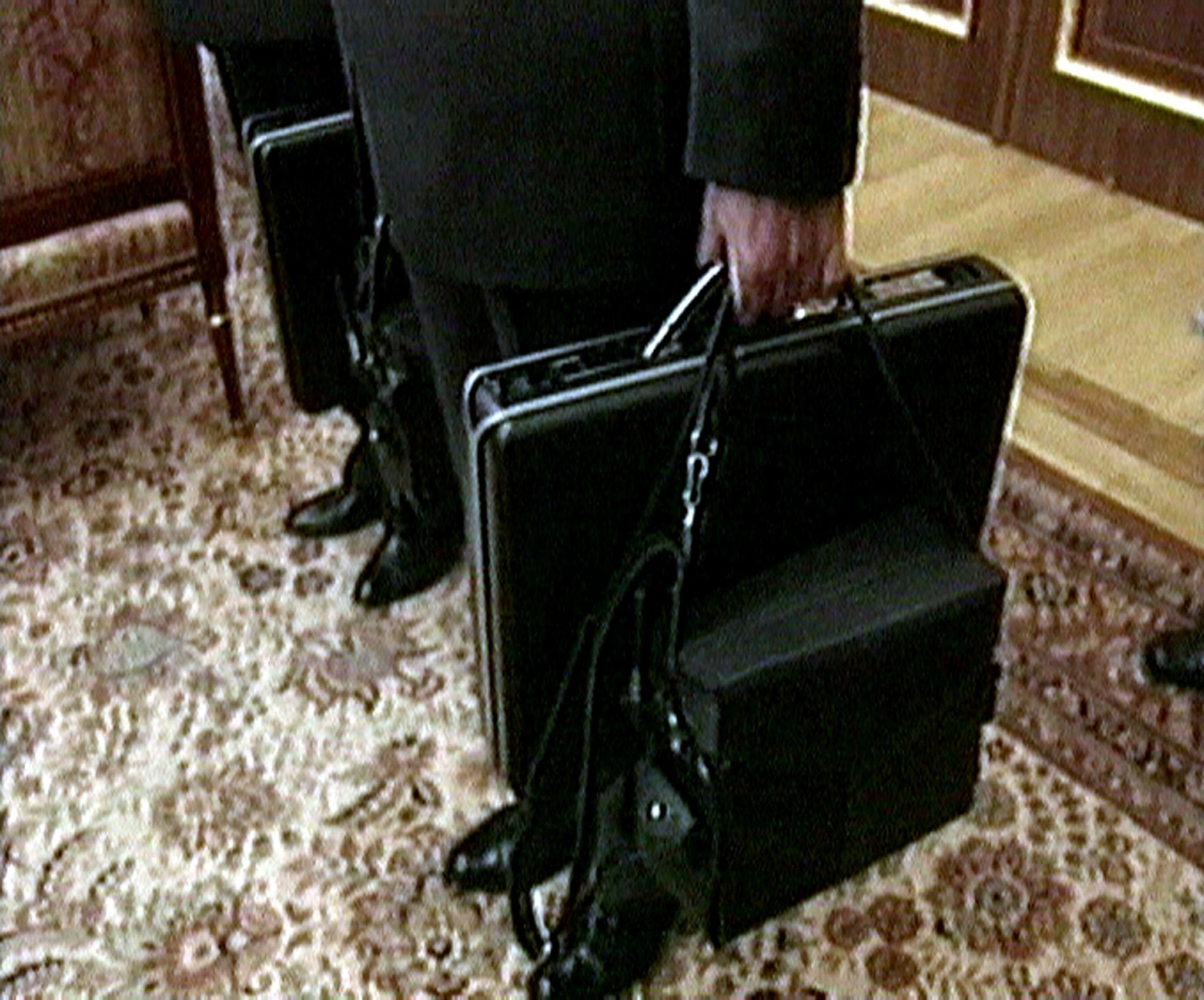 Officers carrying Cheget briefcases