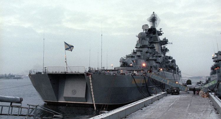 Kirov-class cruiser alongside a snowy pier in winter, St Andrew's flag flying, seen from the foredeck side